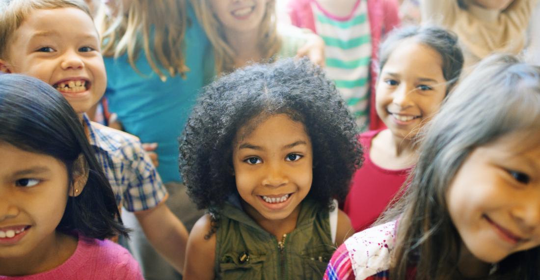 Group of children smiling at camera.