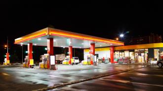 Lit up gas station at night.